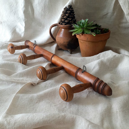 A French vintage faux bamboo wooden coat rack with 4 hanging hooks/pegs. These older type of faux bamboo coat racks are becoming increasingly difficult to source, especially in this excellent condition! There are two metal hanging hooks to the rear for mounting to your wall.

In summary, a wonderful piece of wall decor for any interior, and especially those of a country home, rustic or farmhouse style.