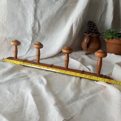 A French vintage faux bamboo wooden coat rack with 4 hanging hooks/pegs. These older type of faux bamboo coat racks are becoming increasingly difficult to source, especially in this excellent condition! There are two metal hanging hooks to the rear for mounting to your wall.

In summary, a wonderful piece of wall decor for any interior, and especially those of a country home, rustic or farmhouse style.