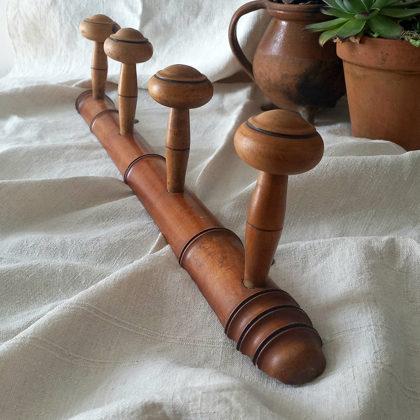 A French vintage faux bamboo wooden coat rack with 4 hanging hooks/pegs. These older type of faux bamboo coat racks are becoming increasingly difficult to source, especially in this excellent condition! There are two metal hanging hooks to the rear for mounting to your wall.

In summary, a wonderful piece of wall decor for any interior, and especially those of a country home, rustic or farmhouse style.