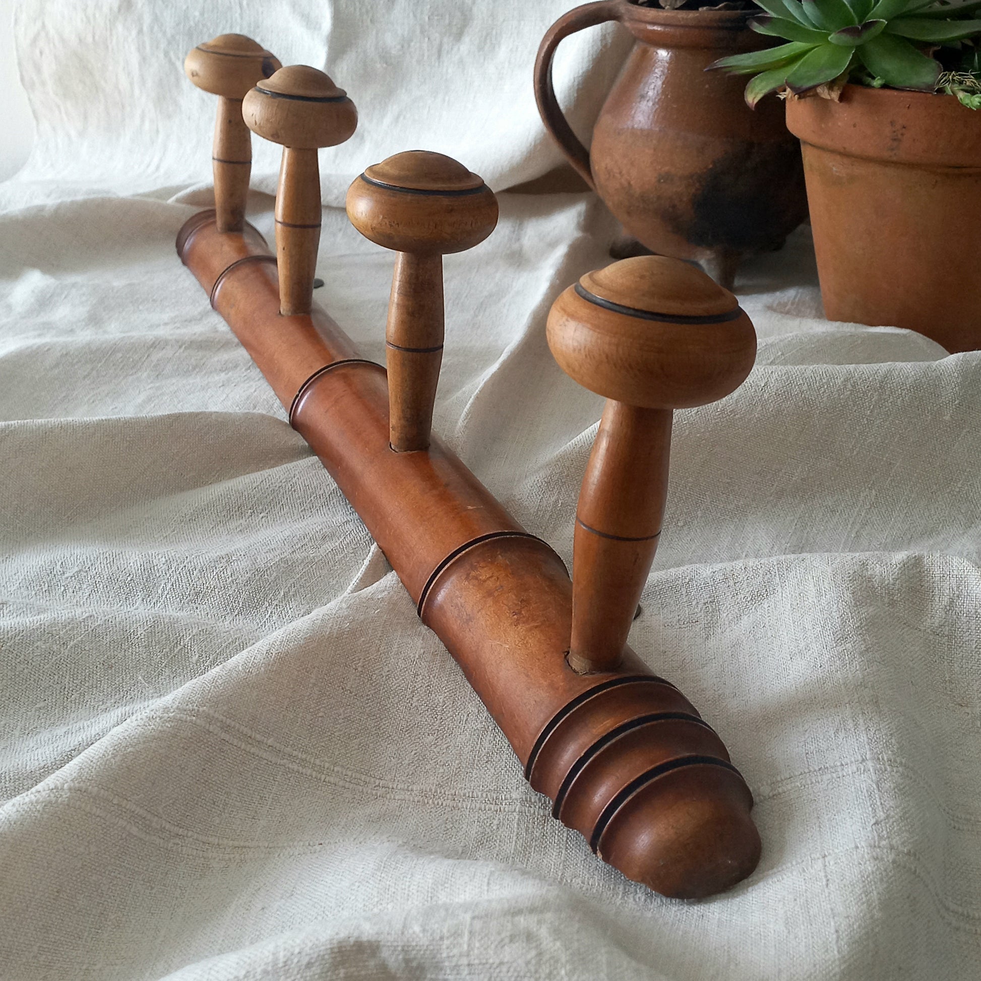 A French vintage faux bamboo wooden coat rack with 4 hanging hooks/pegs. These older type of faux bamboo coat racks are becoming increasingly difficult to source, especially in this excellent condition! There are two metal hanging hooks to the rear for mounting to your wall.

In summary, a wonderful piece of wall decor for any interior, and especially those of a country home, rustic or farmhouse style.