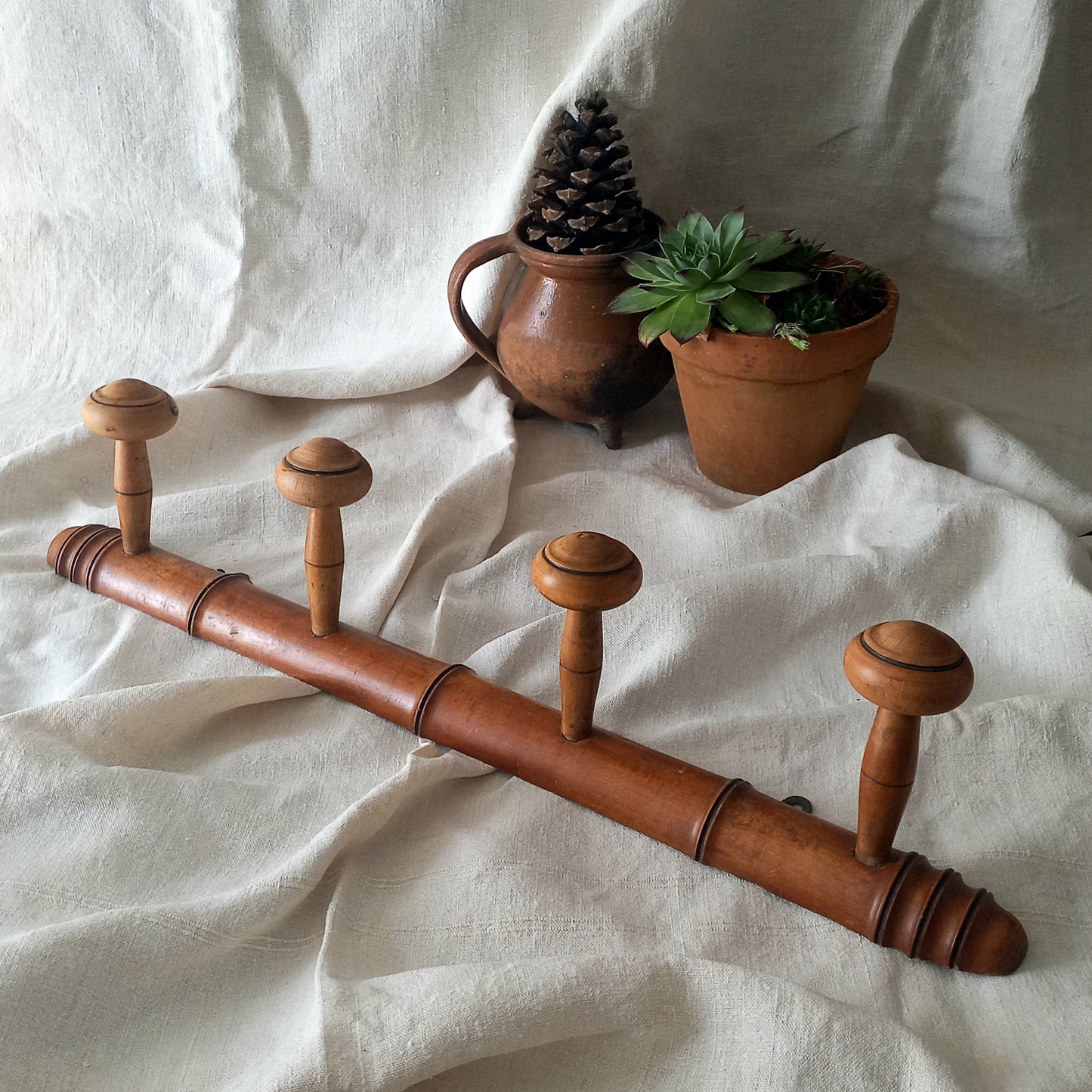 A French vintage faux bamboo wooden coat rack with 4 hanging hooks/pegs. These older type of faux bamboo coat racks are becoming increasingly difficult to source, especially in this excellent condition! There are two metal hanging hooks to the rear for mounting to your wall.

In summary, a wonderful piece of wall decor for any interior, and especially those of a country home, rustic or farmhouse style.