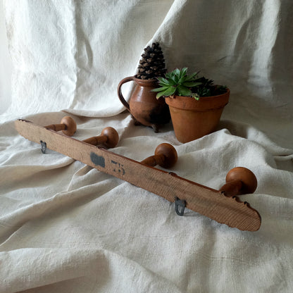 A French vintage faux bamboo wooden coat rack with 4 hanging hooks/pegs. These older type of faux bamboo coat racks are becoming increasingly difficult to source, especially in this excellent condition! There are two metal hanging hooks to the rear for mounting to your wall.

In summary, a wonderful piece of wall decor for any interior, and especially those of a country home, rustic or farmhouse style.