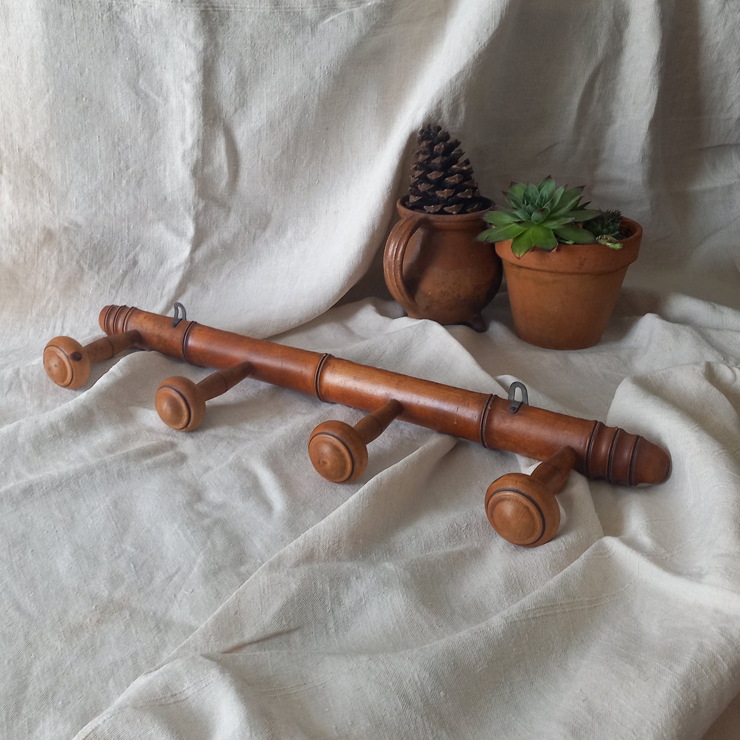A French vintage faux bamboo wooden coat rack with 4 hanging hooks/pegs. These older type of faux bamboo coat racks are becoming increasingly difficult to source, especially in this excellent condition! There are two metal hanging hooks to the rear for mounting to your wall.

In summary, a wonderful piece of wall decor for any interior, and especially those of a country home, rustic or farmhouse style.