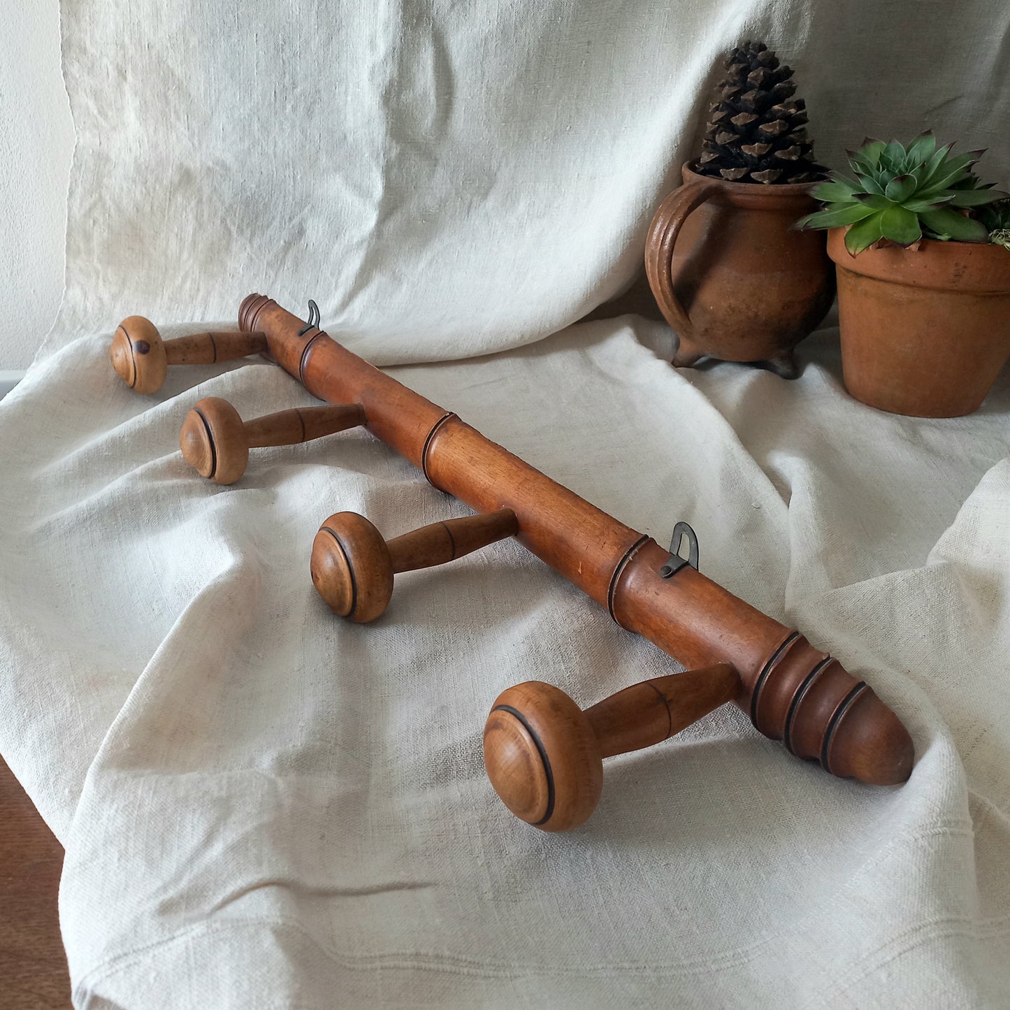 A French vintage faux bamboo wooden coat rack with 4 hanging hooks/pegs. These older type of faux bamboo coat racks are becoming increasingly difficult to source, especially in this excellent condition! There are two metal hanging hooks to the rear for mounting to your wall.

In summary, a wonderful piece of wall decor for any interior, and especially those of a country home, rustic or farmhouse style.