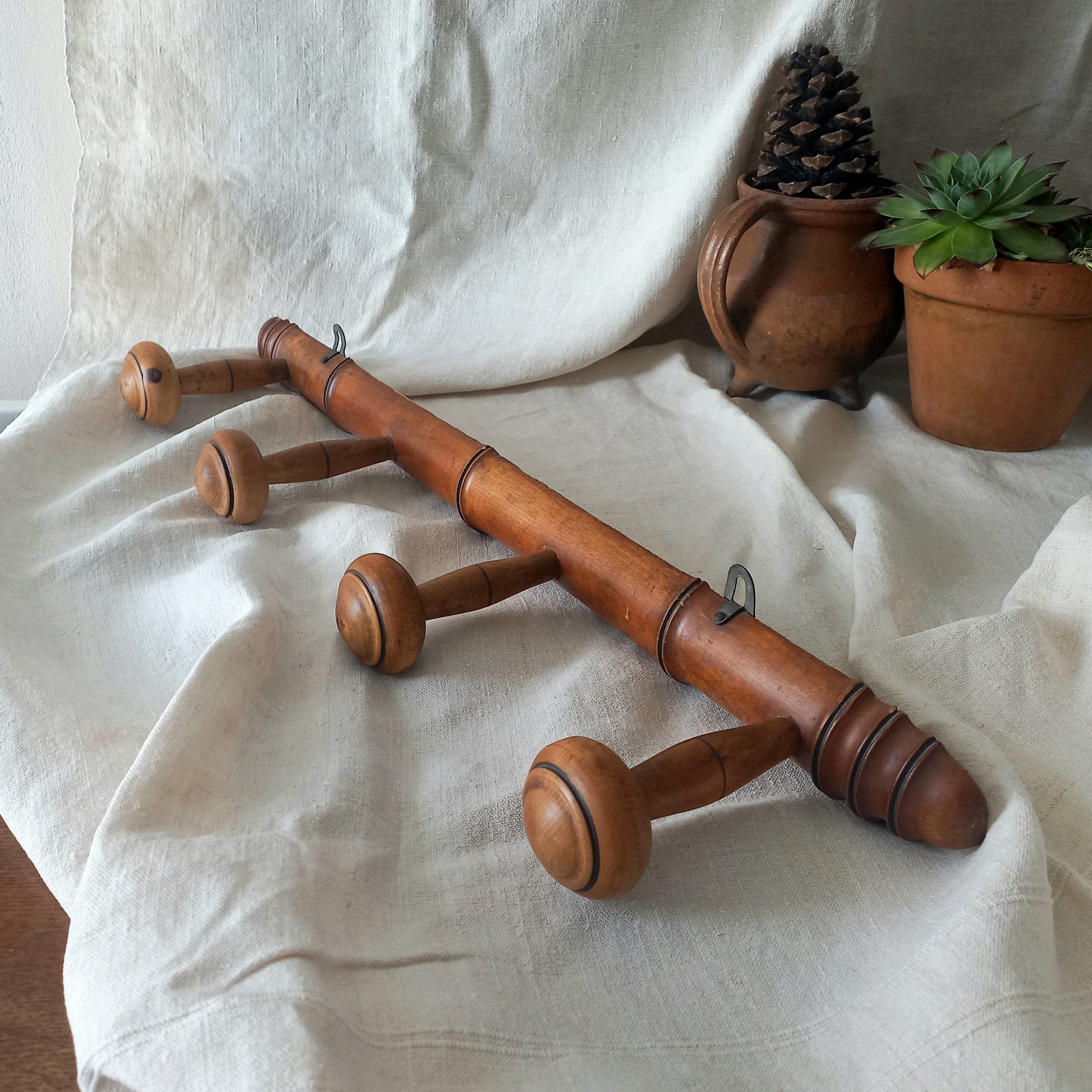 A French vintage faux bamboo wooden coat rack with 4 hanging hooks/pegs. These older type of faux bamboo coat racks are becoming increasingly difficult to source, especially in this excellent condition! There are two metal hanging hooks to the rear for mounting to your wall.

In summary, a wonderful piece of wall decor for any interior, and especially those of a country home, rustic or farmhouse style.