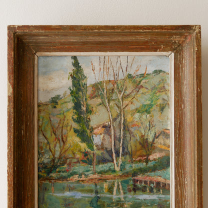 An original vintage landscape oil painting depicting a charming country home in among a wooded area with hills in the background. In the foreground a gentle river reflects the trees in the background.

The painting has been painted by an experienced artist with confident brush strokes - a really wonderful piece of original art.

The painting is presented in an old worn wooden frame which we love and think others will too - it really suits this piece. 
