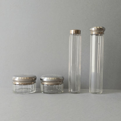 A set of 4 small French vintage decorative glass perfume/scent bottles/make-up containers that will make pleasing decorative pieces in your interior.