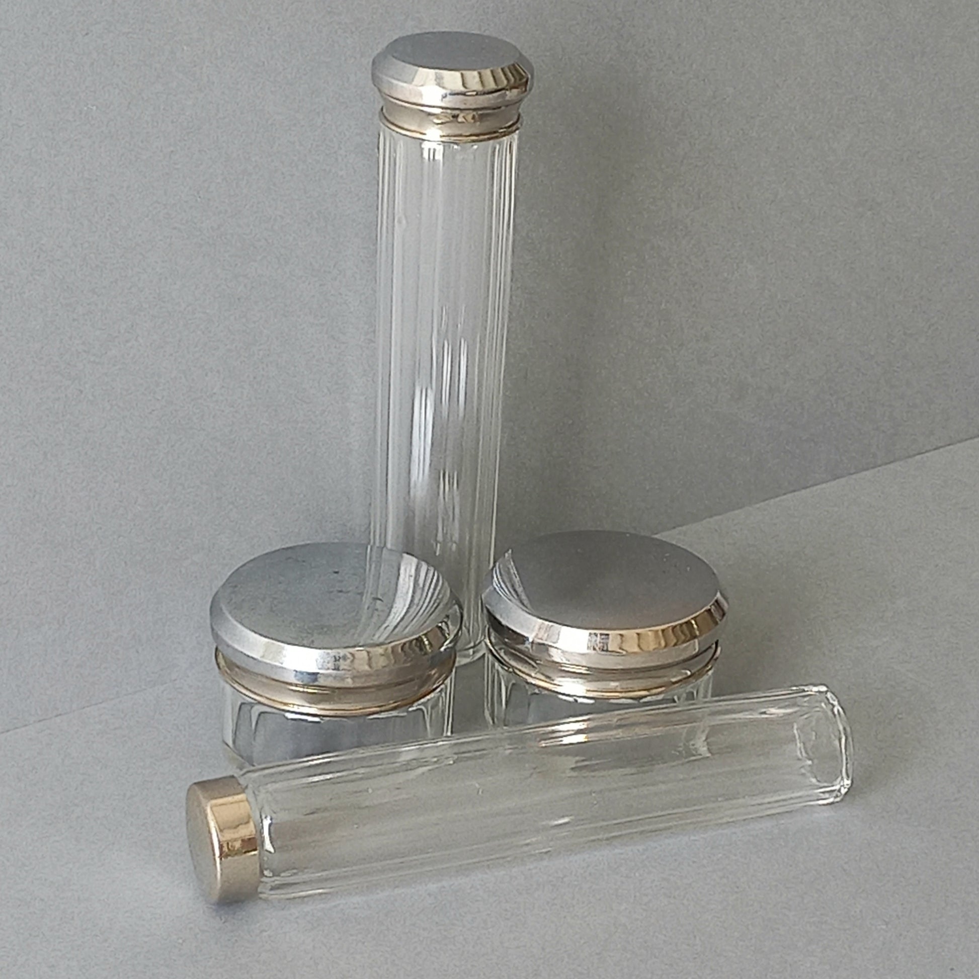 A set of 4 small French vintage decorative glass perfume/scent bottles/make-up containers that will make pleasing decorative pieces in your interior.