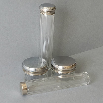 A set of 4 small French vintage decorative glass perfume/scent bottles/make-up containers that will make pleasing decorative pieces in your interior.