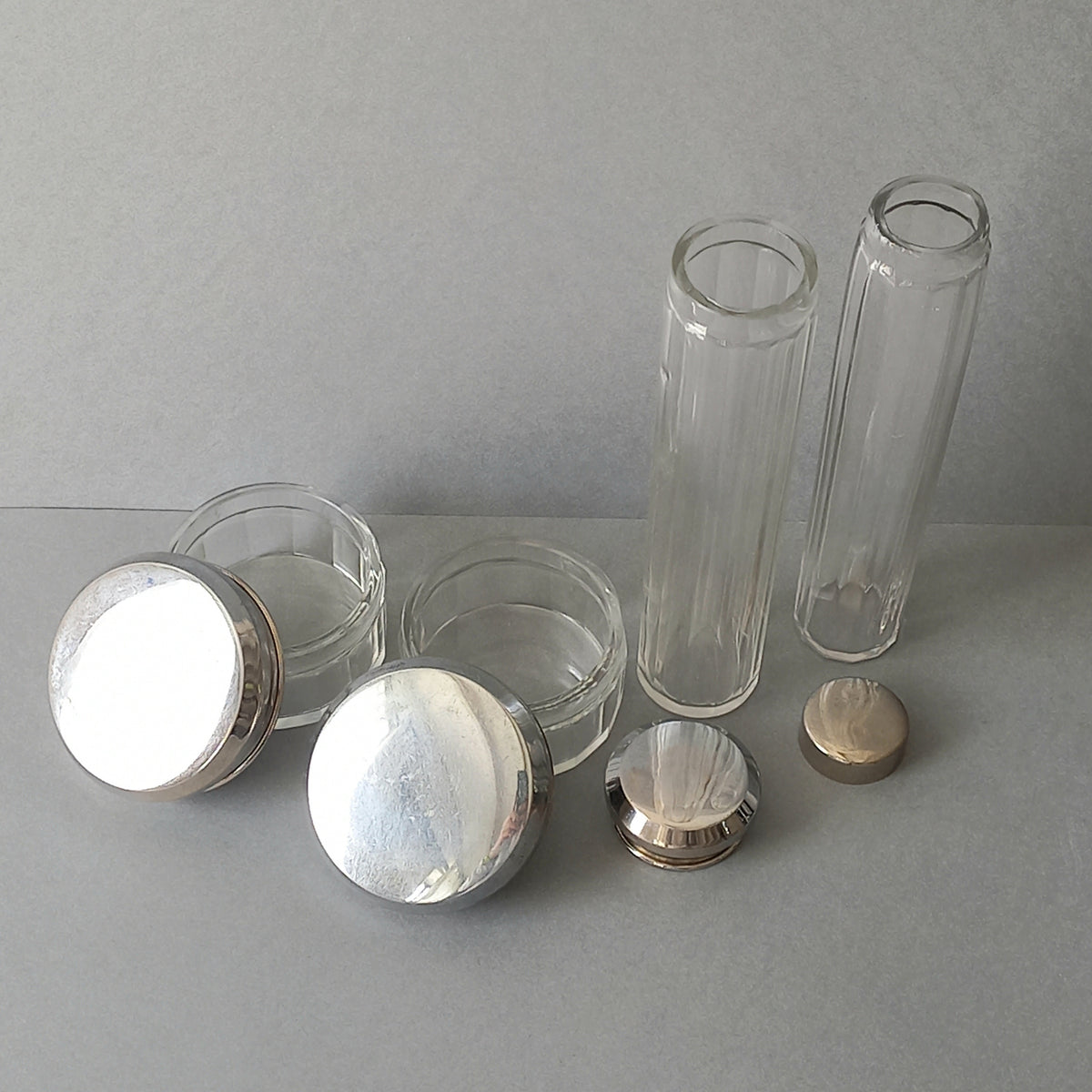 A set of 4 small French vintage decorative glass perfume/scent bottles/make-up containers that will make pleasing decorative pieces in your interior.