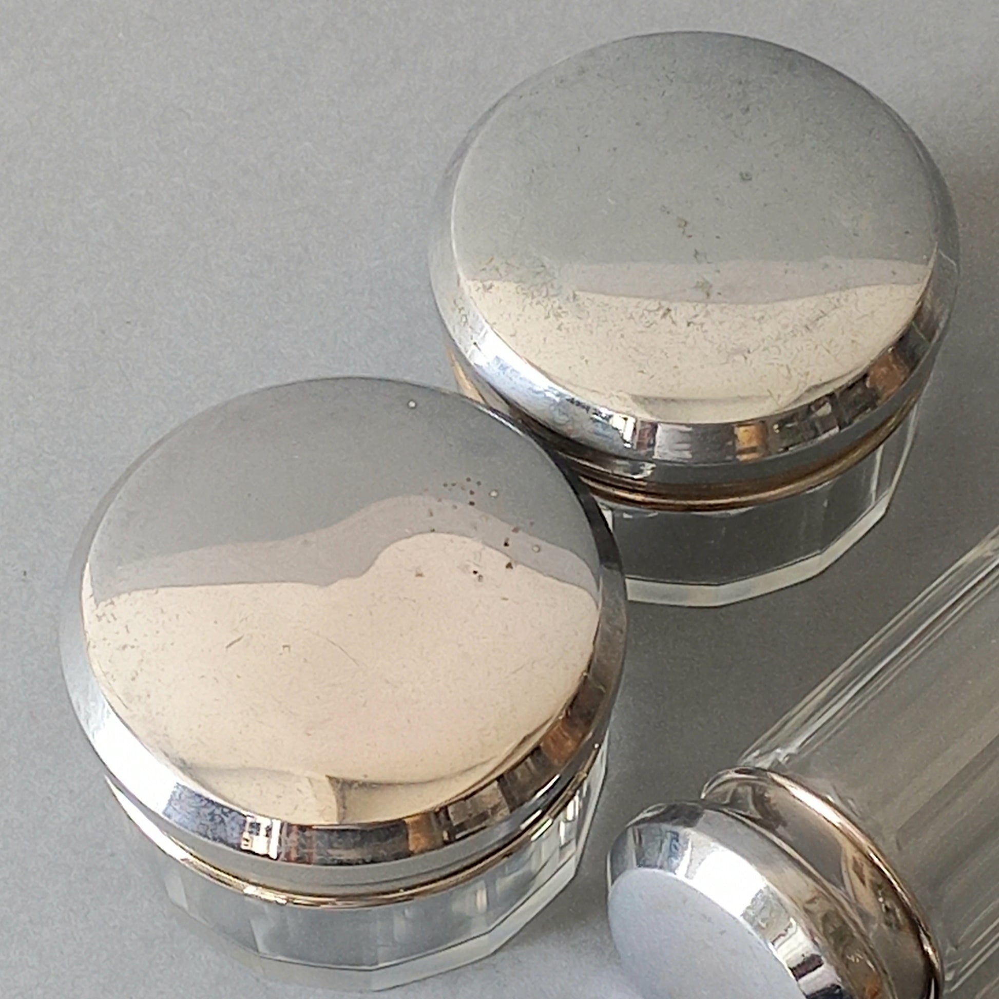 A set of 4 small French vintage decorative glass perfume/scent bottles/make-up containers that will make pleasing decorative pieces in your interior.