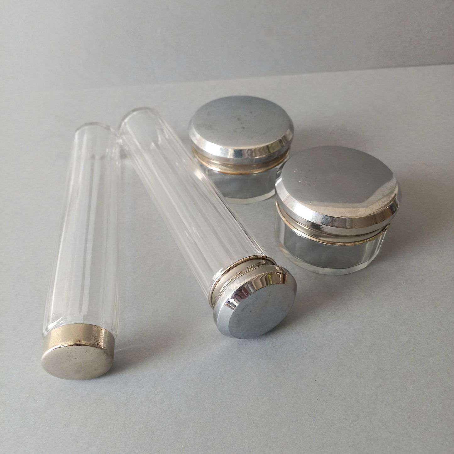 A set of 4 small French vintage decorative glass perfume/scent bottles/make-up containers that will make pleasing decorative pieces in your interior.