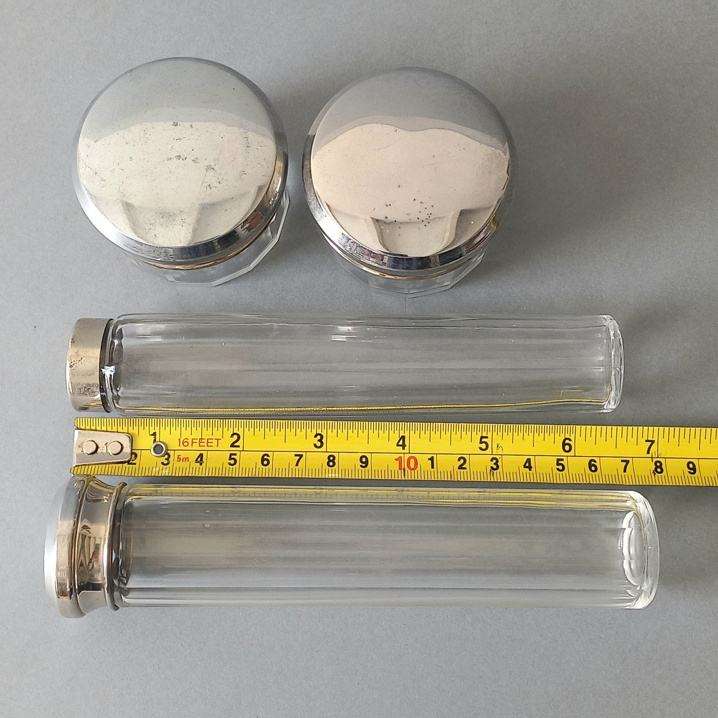 A set of 4 small French vintage decorative glass perfume/scent bottles/make-up containers that will make pleasing decorative pieces in your interior.