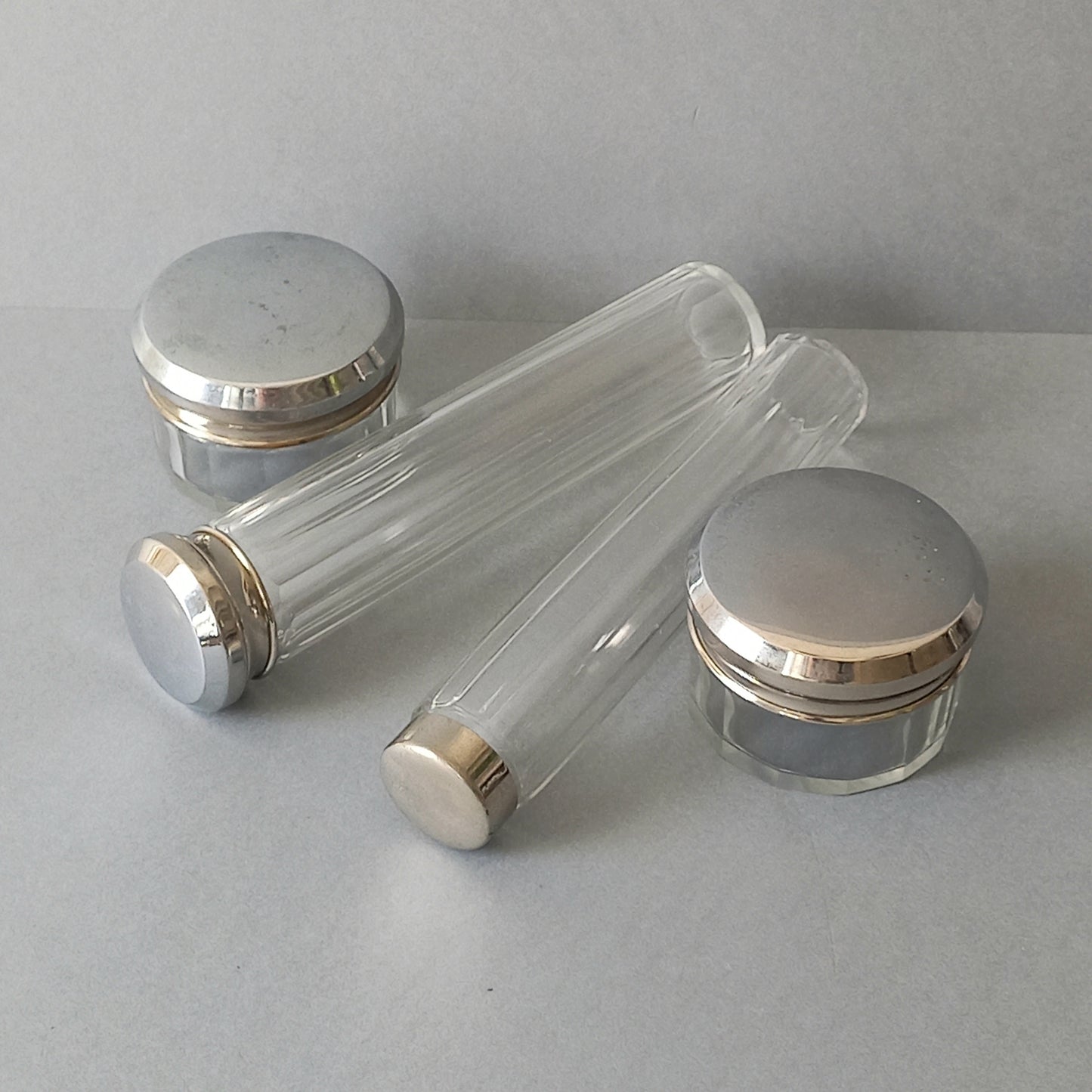 A set of 4 small French vintage decorative glass perfume/scent bottles/make-up containers that will make pleasing decorative pieces in your interior.