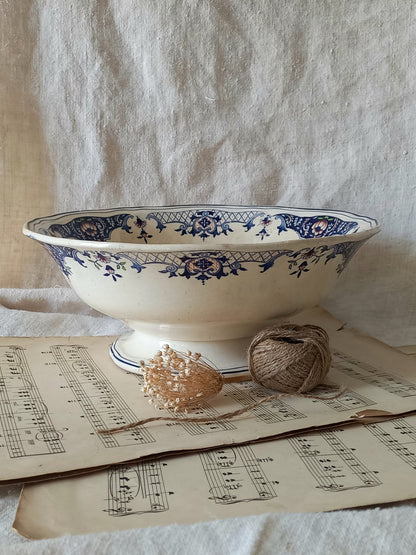 Large French antique decorative footed bowl with a stunning floral pattern in a decorative setting.