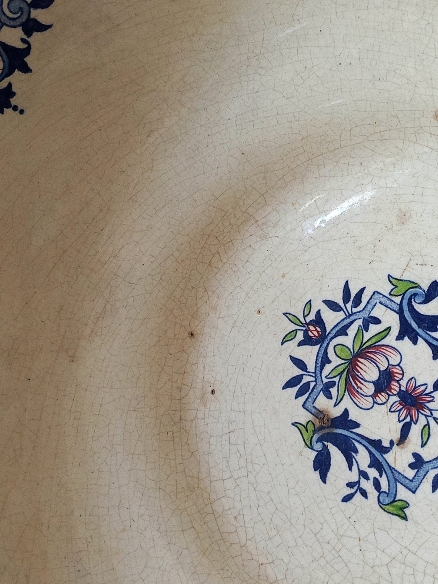 Close-up of a large French antique decorative footed bowl with a stunning floral pattern in a decorative setting .
