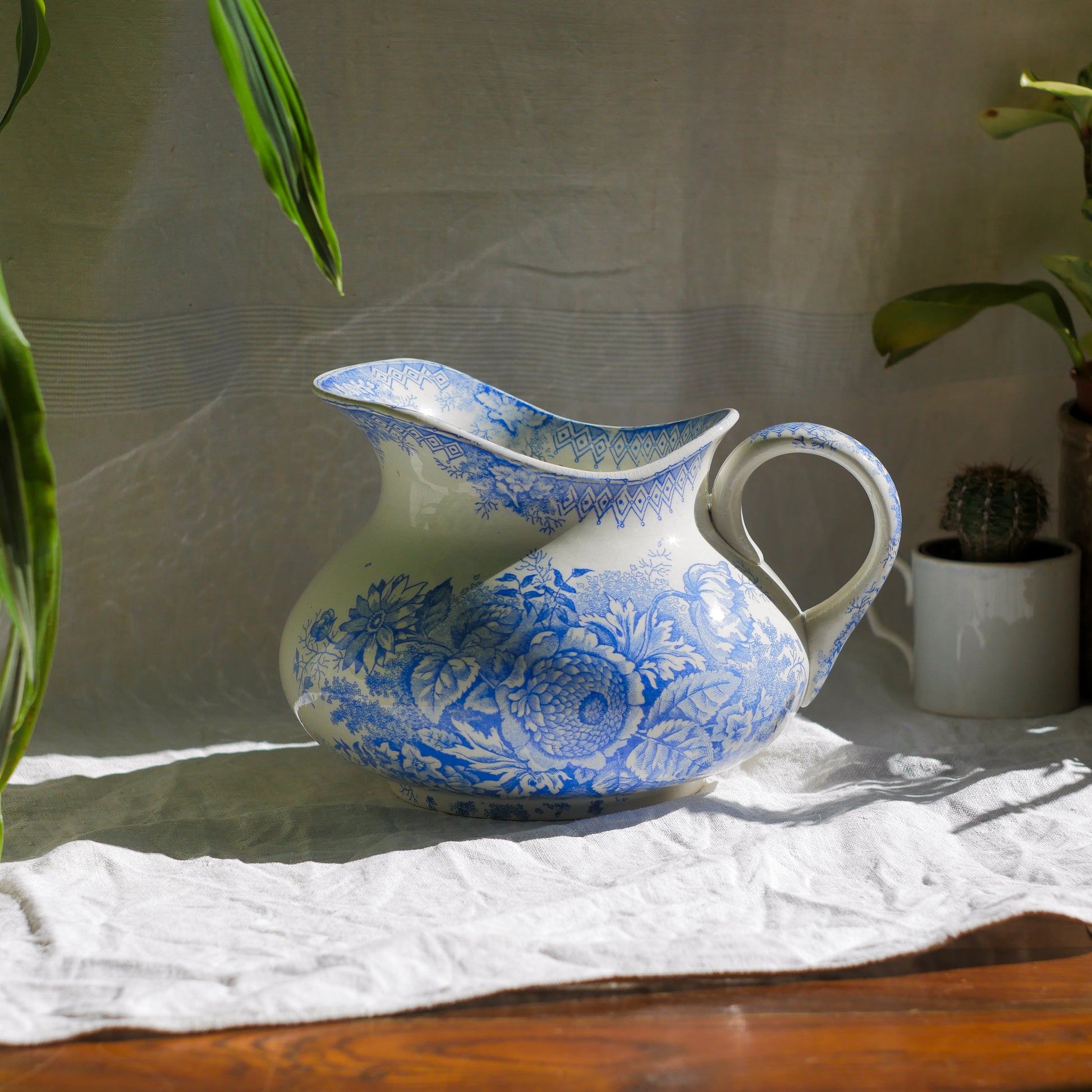 A beautiful French antique white ironstone jug with a pretty floral blue pattern. Once used as wash jugs these days these lovely old jugs make super pieces of home decor. The maker's mark is clearly identified underneath. A wonderful piece of antique ironstone!

Circa: late 1800s/early 1900s.