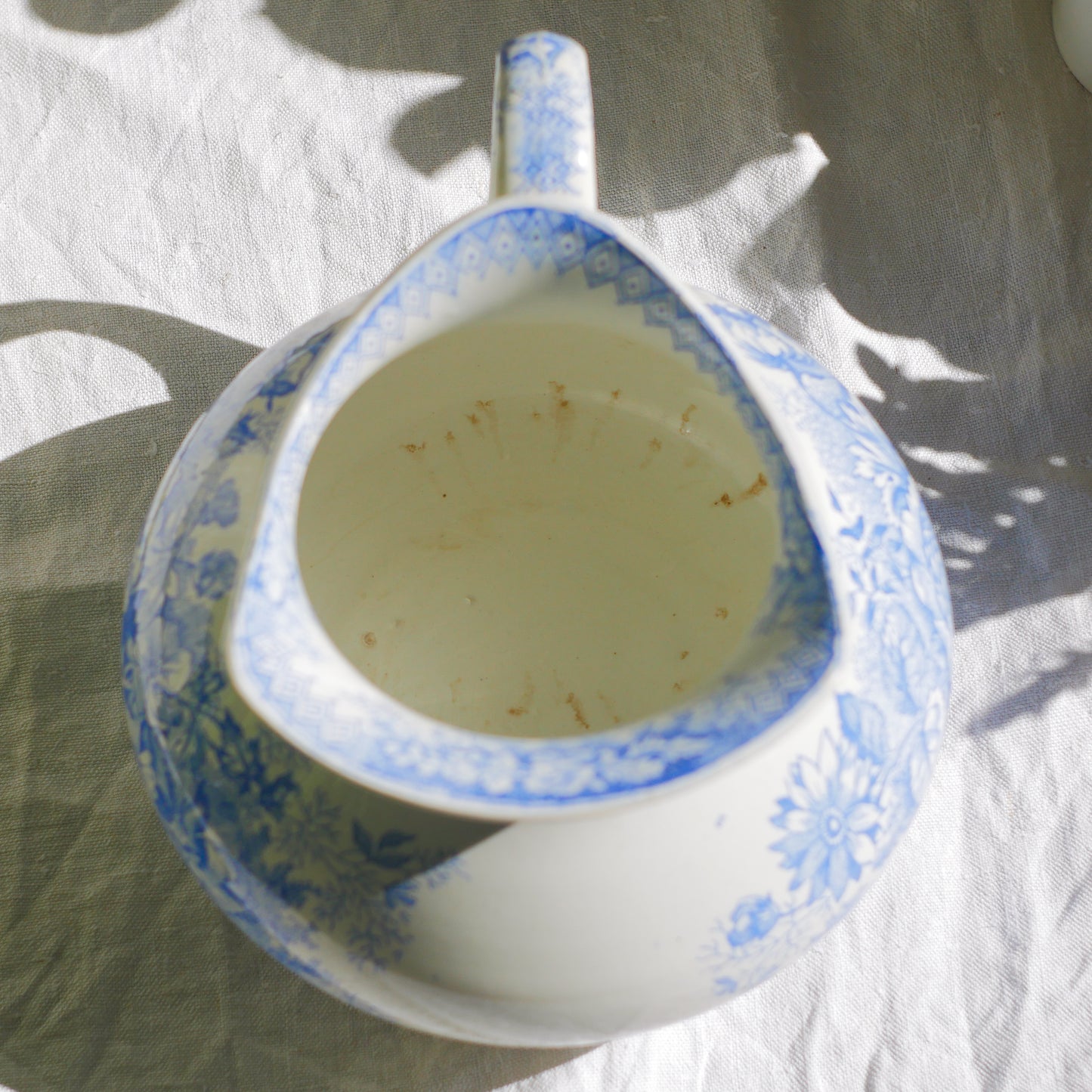 A beautiful French antique white ironstone jug with a pretty floral blue pattern. Once used as wash jugs these days these lovely old jugs make super pieces of home decor. The maker's mark is clearly identified underneath. A wonderful piece of antique ironstone!

Circa: late 1800s/early 1900s.