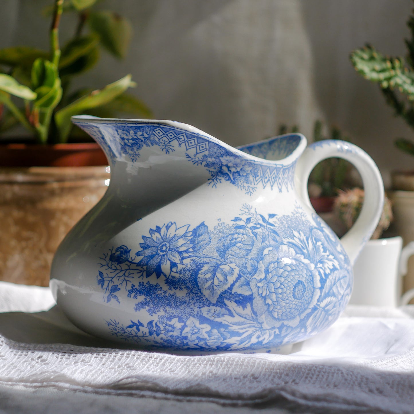 A beautiful French antique white ironstone jug with a pretty floral blue pattern. Once used as wash jugs these days these lovely old jugs make super pieces of home decor. The maker's mark is clearly identified underneath. A wonderful piece of antique ironstone!

Circa: late 1800s/early 1900s.