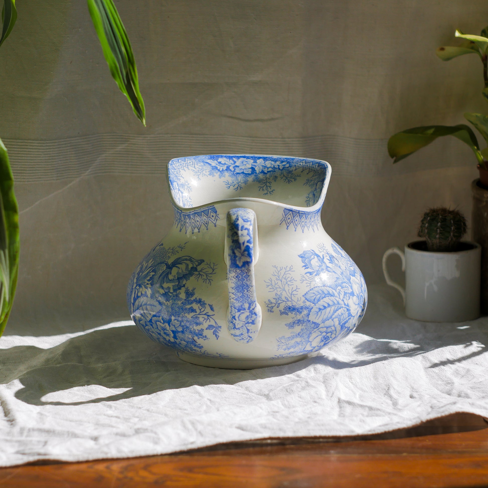 A beautiful French antique white ironstone jug with a pretty floral blue pattern. Once used as wash jugs these days these lovely old jugs make super pieces of home decor. The maker's mark is clearly identified underneath. A wonderful piece of antique ironstone!

Circa: late 1800s/early 1900s.