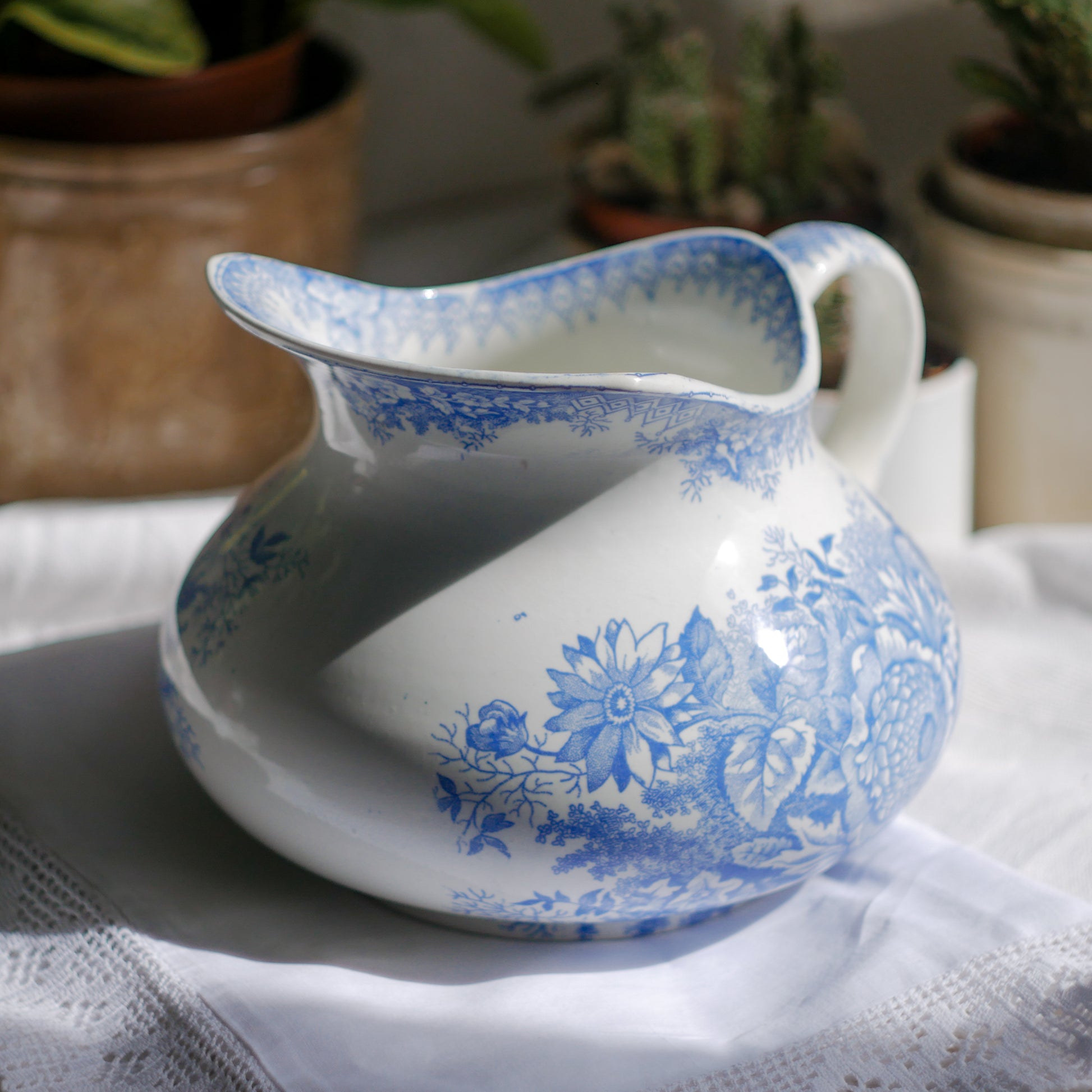 A beautiful French antique white ironstone jug with a pretty floral blue pattern. Once used as wash jugs these days these lovely old jugs make super pieces of home decor. The maker's mark is clearly identified underneath. A wonderful piece of antique ironstone!

Circa: late 1800s/early 1900s.