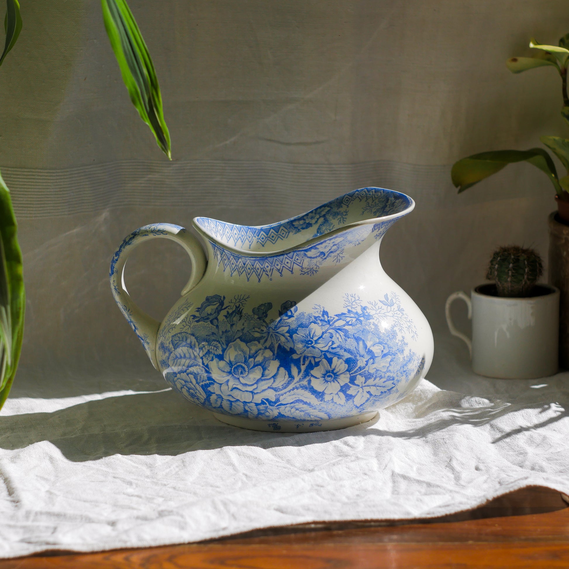 A beautiful French antique white ironstone jug with a pretty floral blue pattern. Once used as wash jugs these days these lovely old jugs make super pieces of home decor. The maker's mark is clearly identified underneath. A wonderful piece of antique ironstone!

Circa: late 1800s/early 1900s.