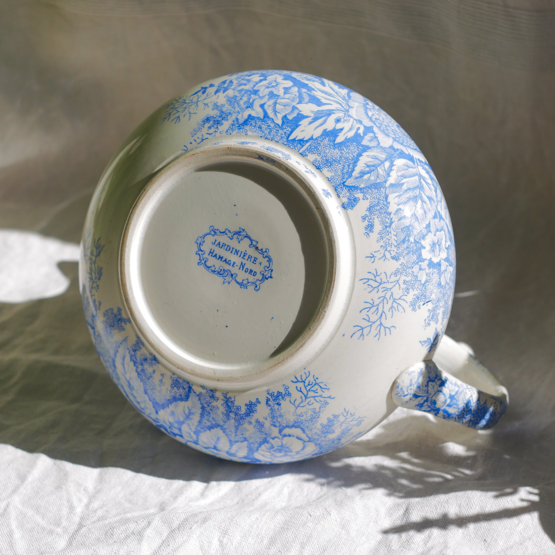 A beautiful French antique white ironstone jug with a pretty floral blue pattern. Once used as wash jugs these days these lovely old jugs make super pieces of home decor. The maker's mark is clearly identified underneath. A wonderful piece of antique ironstone!

Circa: late 1800s/early 1900s.