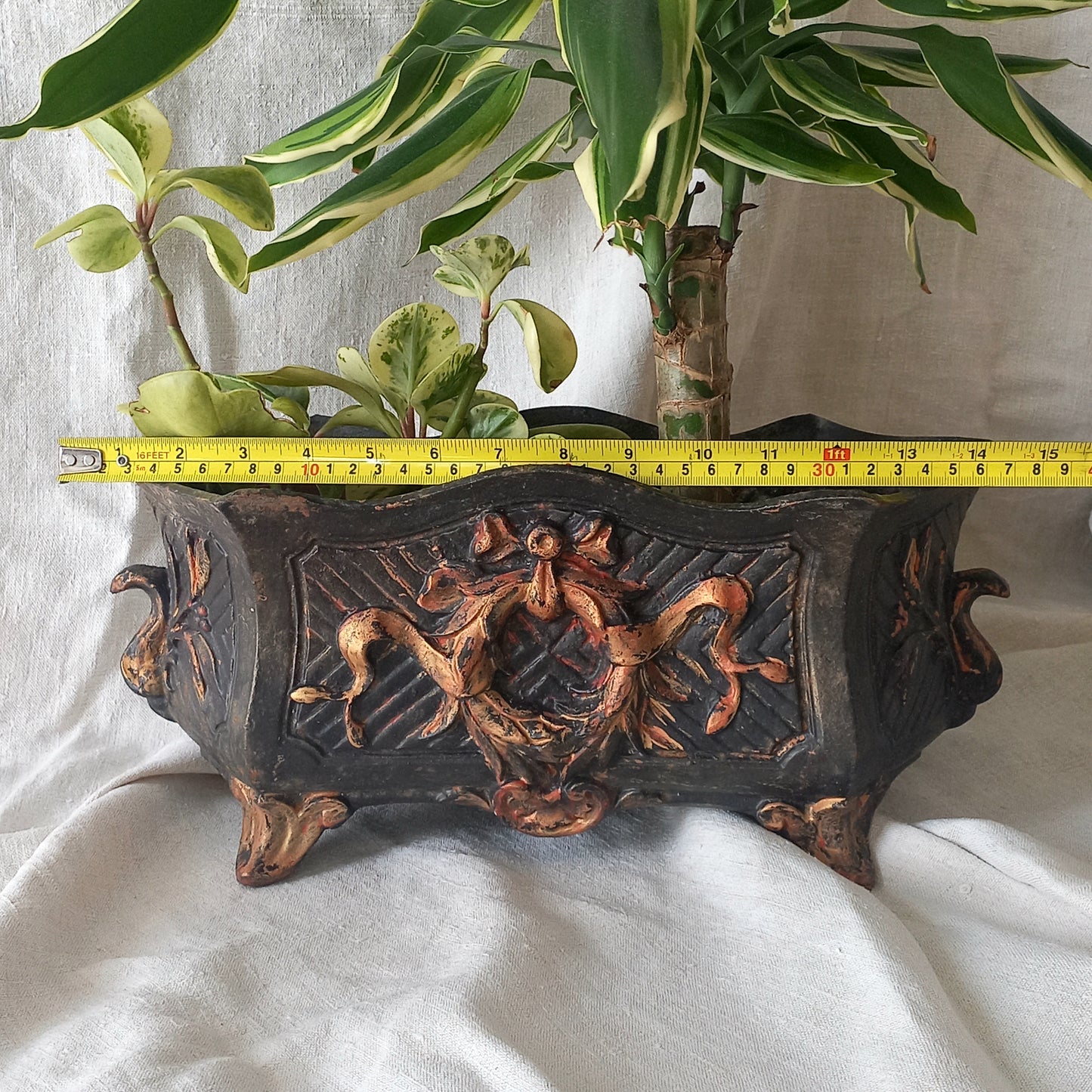 A stunning French antique decorative cast iron planter with patina of age suitable for both interior and exterior use - we rarely come across them these days so this was an exciting find.

The planter is in a striking and wonderfully aged black colour with gold coloured detailing in relief - there's some great paint chipping off areas of the gold paint showing small areas of red beneath, and also chipping from the black paint showing rusty patina, all of which add to the antique character of this beautiful 