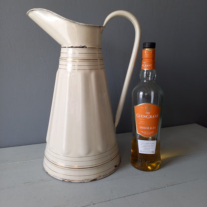 Large antique enamel metal pitcher in cream color with gold trim from France