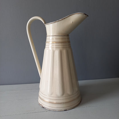 Large antique enamel metal pitcher in cream color with gold trim from France