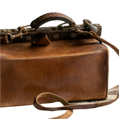 A French vintage leather shoulder/hand bag that's both practical and perfect as a prop or decorative piece in your interior, a beautifully aged piece with just enough patina of age to give it that authentic character. We have polished the distressed leather and thoroughly cleaned the bag both inside and out.