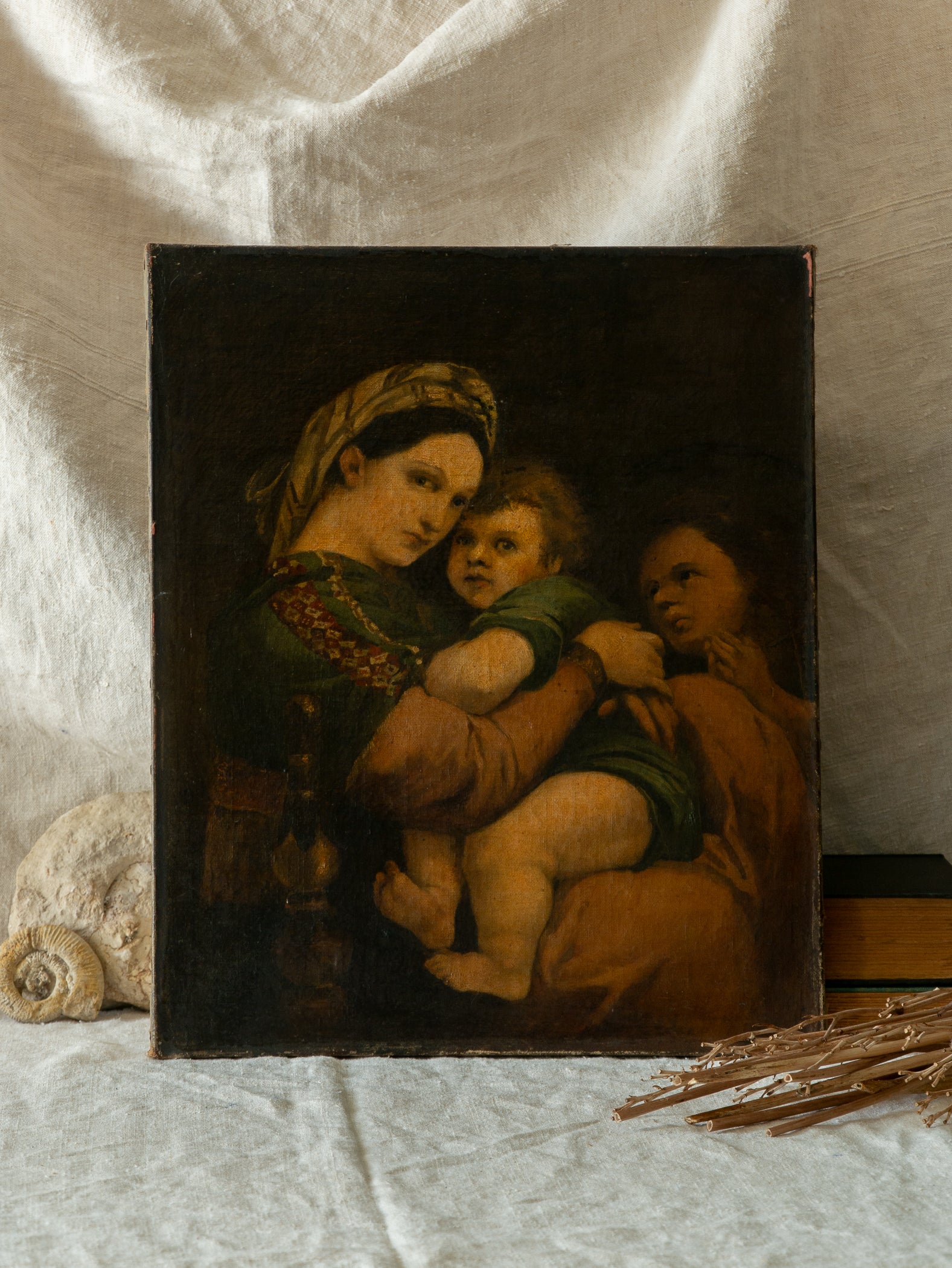 A late 19th-century/early 20th century after Raphael oil painting based on Madonna della Sedia (1513–1514, Pitti Palace, Florence). The artist (perhaps a student of the time) adapts Raphael’s tondo into a rectangular canvas, preserving the iconic green dress with patterned sleeve, the tender embrace, and the young St. John at right against a deep ground.