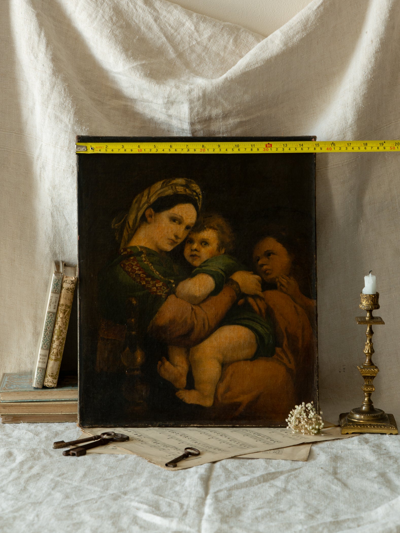 A late 19th-century/early 20th century after Raphael oil painting based on Madonna della Sedia (1513–1514, Pitti Palace, Florence). The artist (perhaps a student of the time) adapts Raphael’s tondo into a rectangular canvas, preserving the iconic green dress with patterned sleeve, the tender embrace, and the young St. John at right against a deep ground.