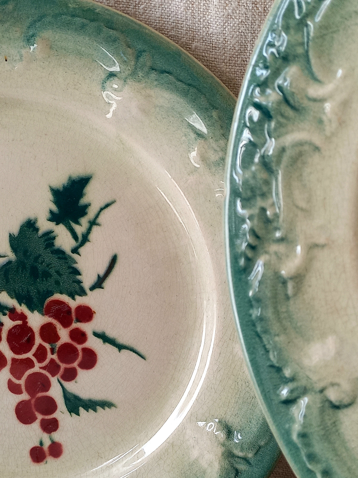 Ceramic plate with floral design and red berries on a textured surface