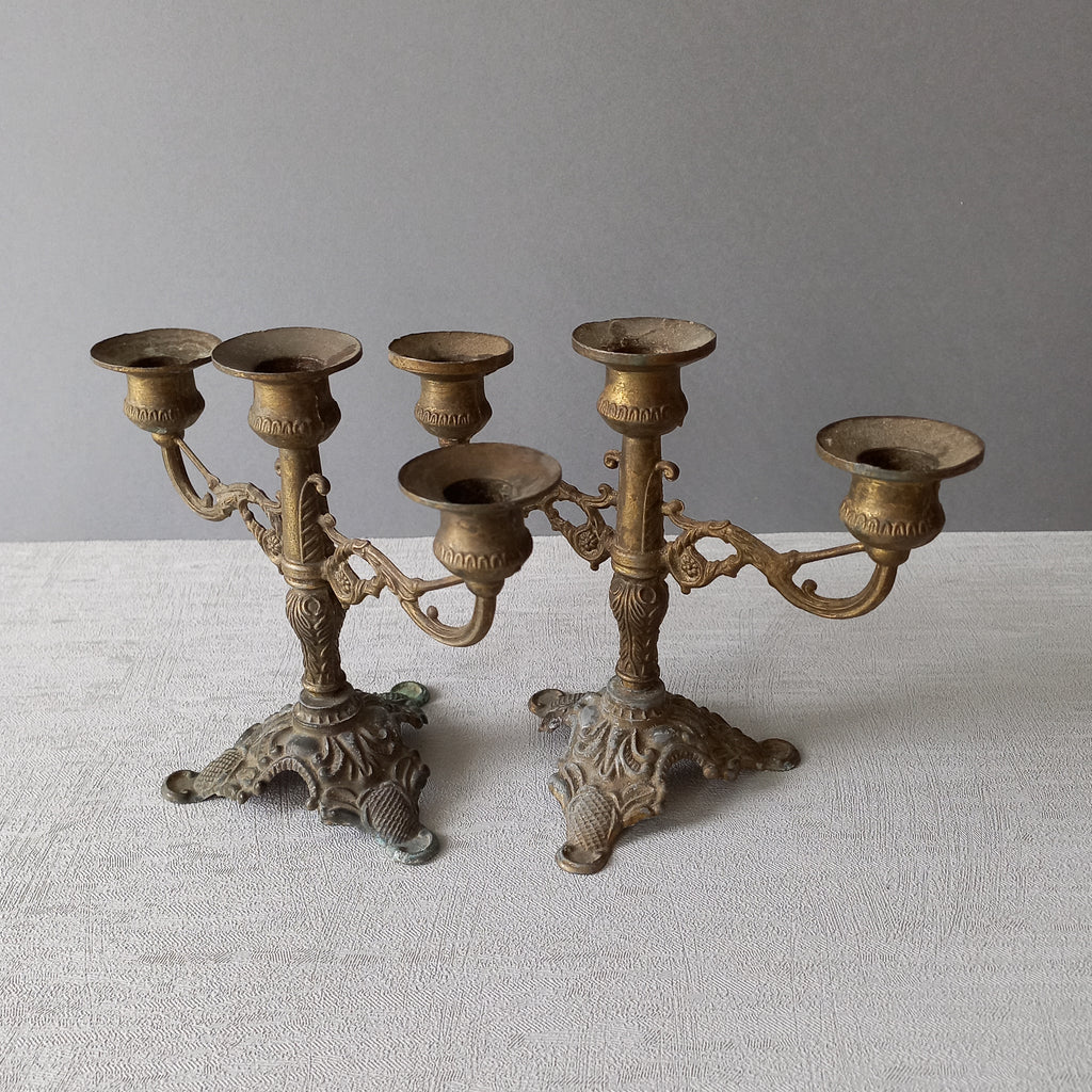A pair of small vintage antique metal candelabras. This pair of decorative candle stick holders will give that touch of French shabby chic to any interior.