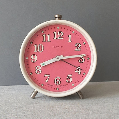 A wonderful vintage alarm clock in an eye-catching white and pink color scheme. This old clock is in working condition including the alarm and has a nice soothing ticking sound too. A great piece of European history from the former country of Czechoslovakia.