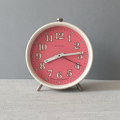 A wonderful vintage alarm clock in an eye-catching white and pink color scheme. This old clock is in working condition including the alarm and has a nice soothing ticking sound too. A great piece of European history from the former country of Czechoslovakia

In summary, a nice vintage alarm clock!