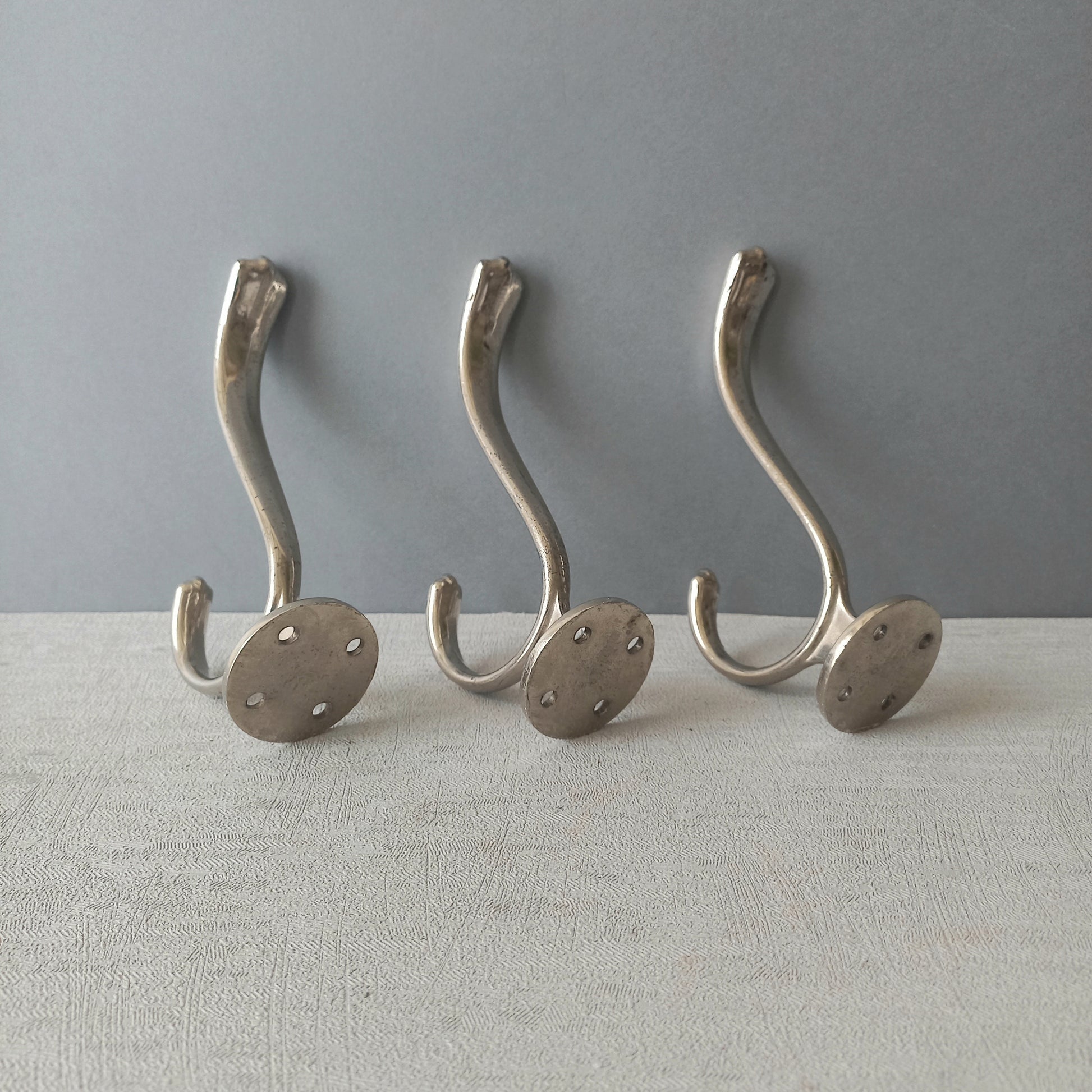 3 x French vintage silver coloured metal coat hooks in used sturdy used condition. Good for coat storage, dog leads, or maybe in the kitchen or bathroom for towels.
Circa. 1930s/1950s.