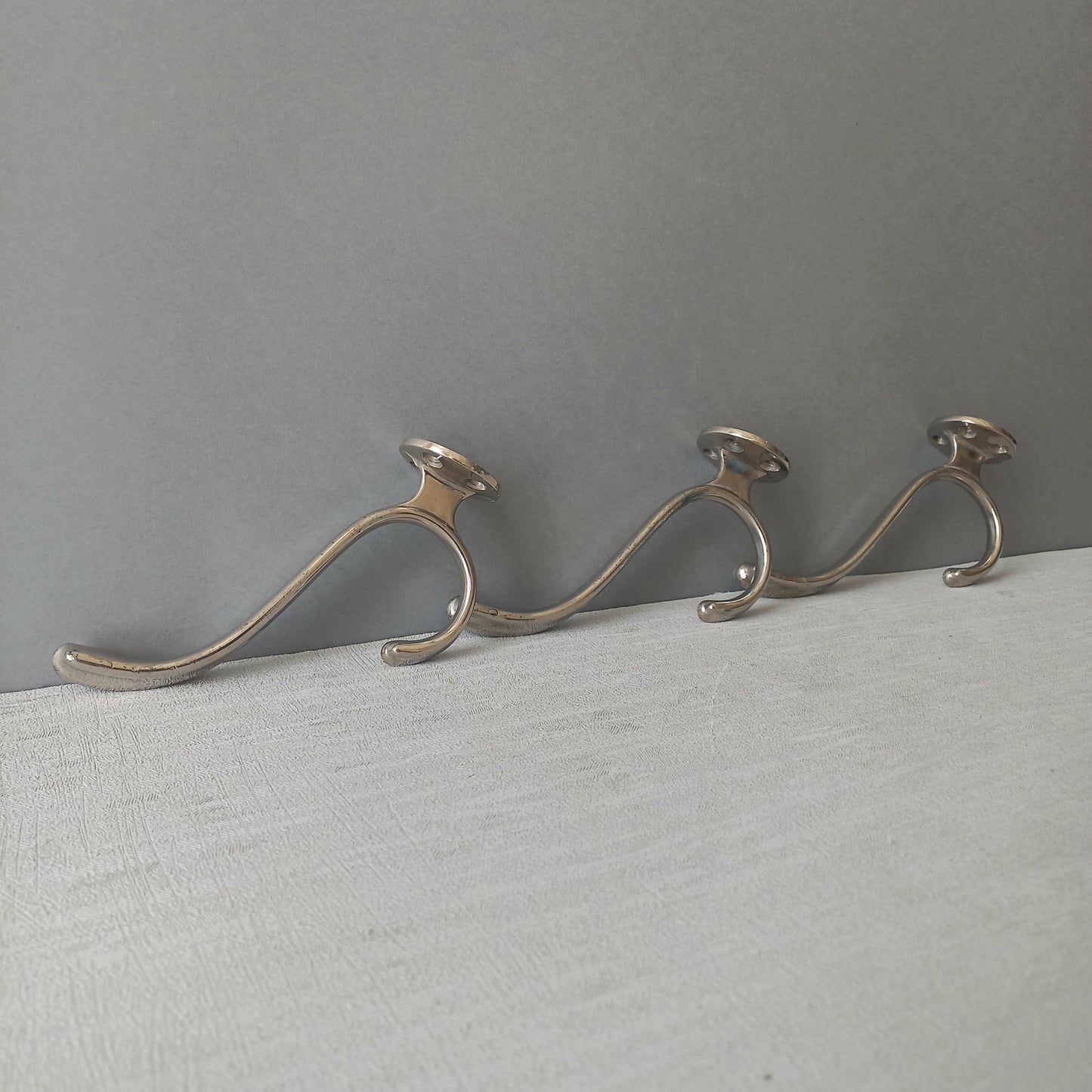 3 x French vintage silver coloured metal coat hooks in used sturdy used condition. Good for coat storage, dog leads, or maybe in the kitchen or bathroom for towels.
Circa. 1930s/1950s.