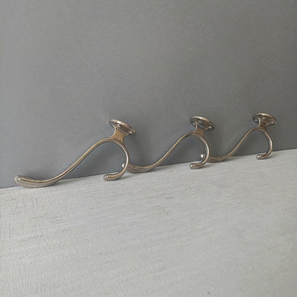 3 x French vintage silver coloured metal coat hooks in used sturdy used condition. Good for coat storage, dog leads, or maybe in the kitchen or bathroom for towels.
Circa. 1930s/1950s.