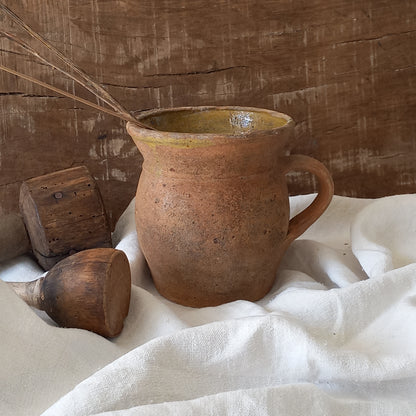A little antique stoneware jug with a glazed interior in a wonderful shade of ochre, so rustic! This piece of pottery has aged beautifully and with its uneven worn edges and earthy rough texture it's perfect for a rustic, country or farmhouse interior.