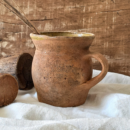 A little antique stoneware jug with a glazed interior in a wonderful shade of ochre, so rustic! This piece of pottery has aged beautifully and with its uneven worn edges and earthy rough texture it's perfect for a rustic, country or farmhouse interior.