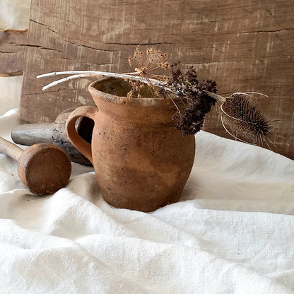 A little antique stoneware jug with a glazed interior in a wonderful shade of ochre, so rustic! This piece of pottery has aged beautifully and with its uneven worn edges and earthy rough texture it's perfect for a rustic, country or farmhouse interior.