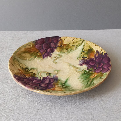 Small and beautiful French antique crazed majolica plate with a wonderful colour scheme depicting dark purple grapes and green foliage; this wonderful old plate will make an excellent addition to a collection or as a stand-alone display piece.