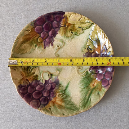 Small and beautiful French antique crazed majolica plate with a wonderful colour scheme depicting dark purple grapes and green foliage; this wonderful old plate will make an excellent addition to a collection or as a stand-alone display piece.