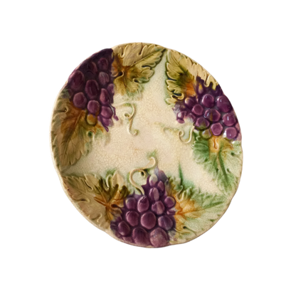 Small and beautiful French antique crazed majolica plate with a wonderful colour scheme depicting dark purple grapes and green foliage; this wonderful old plate will make an excellent addition to a collection or as a stand-alone display piece.