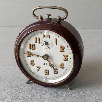 A handsome little vintage alarm clock by premier French manufacturer, Jaz.

This wonderful little clock is in semi-working condition including the alarm, although I should note that being an old time piece dating from the pre-1940 period he's temperamental and sometimes will just stop working, although all that's needed is a gentle shake from side to side and he will once more begin to tick - sometimes you might have to repeat this and have patience with him.