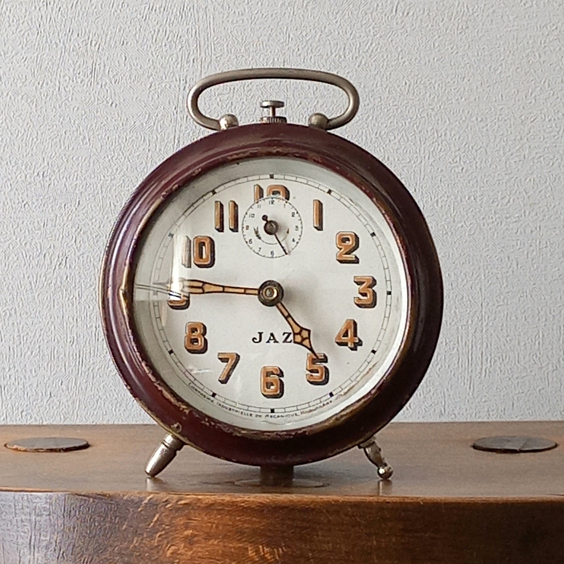 A handsome little vintage alarm clock by premier French manufacturer, Jaz.

This wonderful little clock is in semi-working condition including the alarm, although I should note that being an old time piece dating from the pre-1940 period he's temperamental and sometimes will just stop working, although all that's needed is a gentle shake from side to side and he will once more begin to tick - sometimes you might have to repeat this and have patience with him.