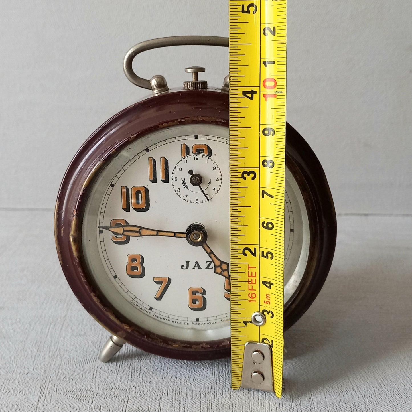 A handsome little vintage alarm clock by premier French manufacturer, Jaz.

This wonderful little clock is in semi-working condition including the alarm, although I should note that being an old time piece dating from the pre-1940 period he's temperamental and sometimes will just stop working, although all that's needed is a gentle shake from side to side and he will once more begin to tick - sometimes you might have to repeat this and have patience with him.