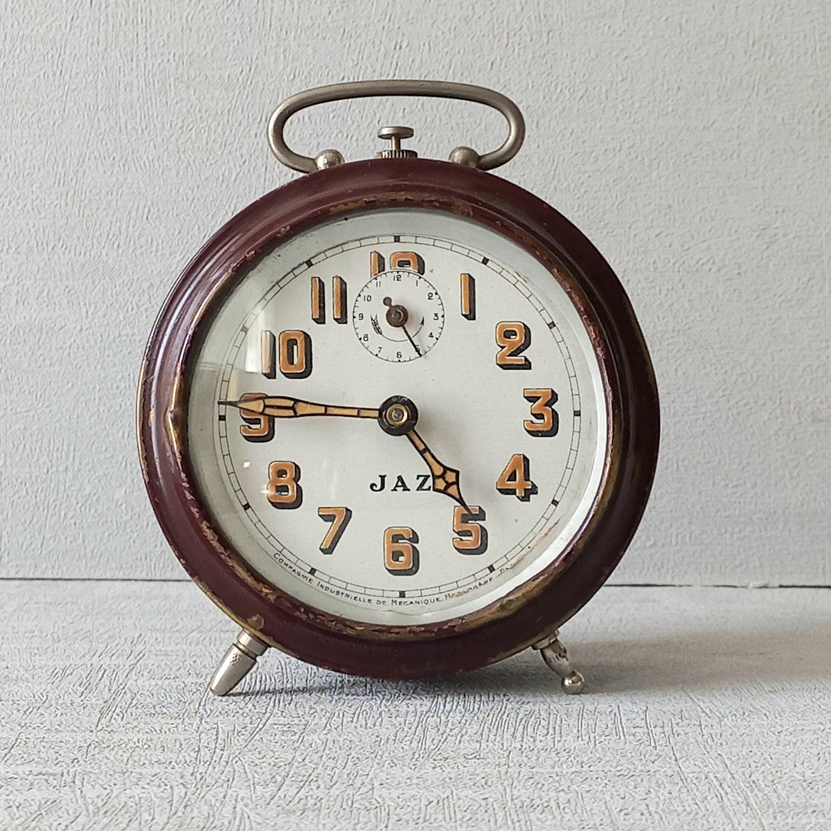 A handsome little vintage alarm clock by premier French manufacturer, Jaz.

This wonderful little clock is in semi-working condition including the alarm, although I should note that being an old time piece dating from the pre-1940 period he's temperamental and sometimes will just stop working, although all that's needed is a gentle shake from side to side and he will once more begin to tick - sometimes you might have to repeat this and have patience with him.